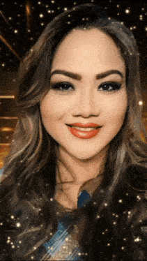 a close up of a woman 's face with sparkles coming out of her hair