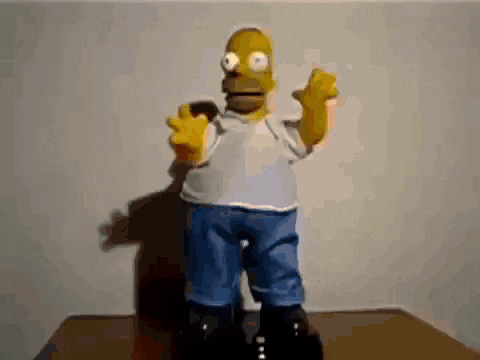 a homer simpson doll is standing on a table
