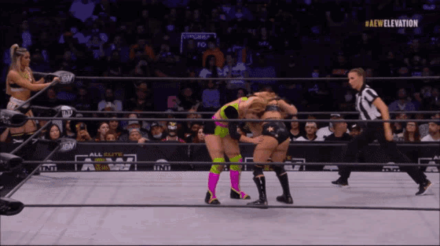 two women wrestle in a ring with the aew elevation logo on the bottom right