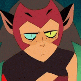 catra from she ra and the princesses of power is a cartoon character with a serious look on her face .