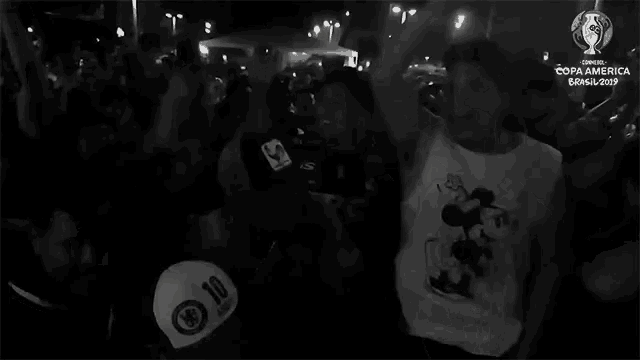 a man wearing a mickey mouse shirt has the number 10 on his back