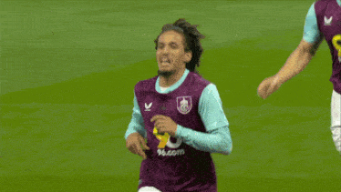 a soccer player in a purple jersey with the number 28 on it celebrates a goal