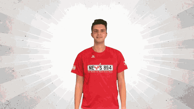 a man in a red shirt that says news 894 on it