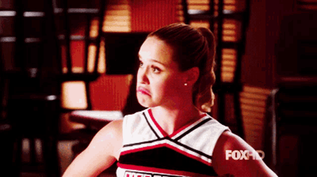 a cheerleader with the word fox on her chest