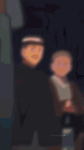a blurry picture of two anime characters holding each other