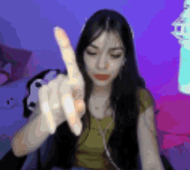 a blurry picture of a woman with long hair giving the middle finger