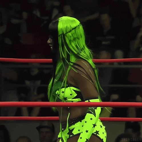a woman in a green outfit with the letter t on her top