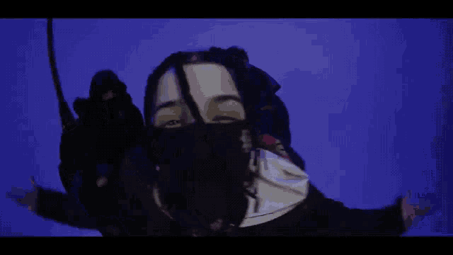 a man with dreadlocks wearing a bandana that says p on it