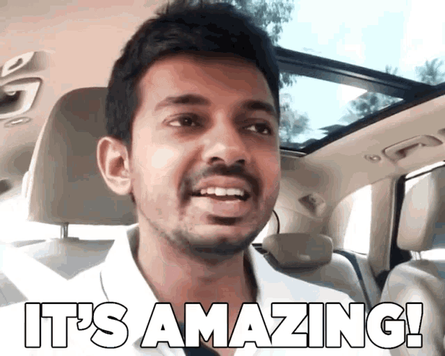 a man in a car with the words " it 's amazing " on his face