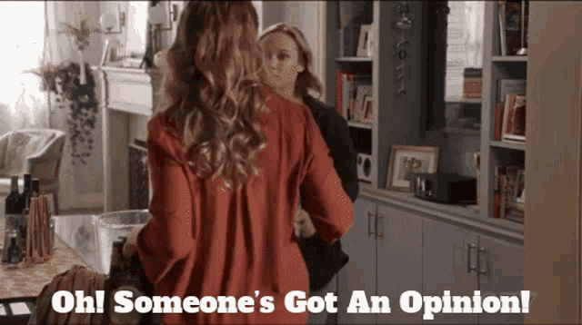 two women standing in a living room with the words oh someone 's got an opinion below them
