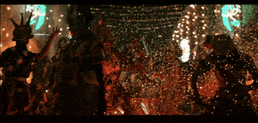 a group of people are dancing in front of a green sign that says ' a ' on it