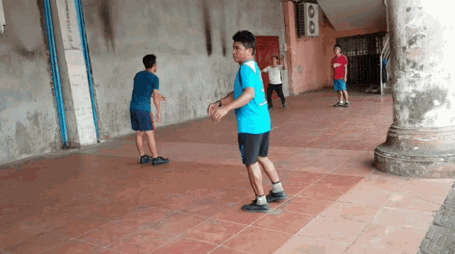 a boy in a blue shirt is playing a game with a girl in a red shirt