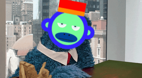 a stuffed animal with a monkey face on it sits at a table