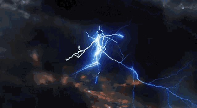 a lightning bolt is flying through a dark cloudy sky at night .