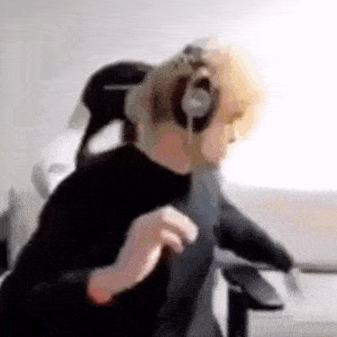 a man wearing headphones is dancing in a room .