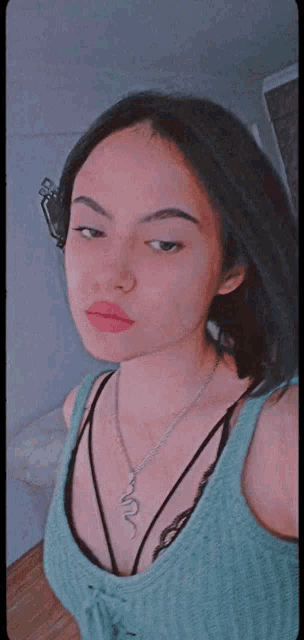 a girl wearing a necklace with a snake pendant
