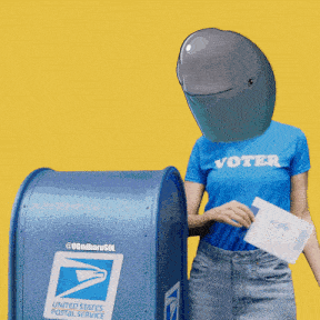 a woman wearing a blue shirt that says voter is putting a piece of paper into a mailbox