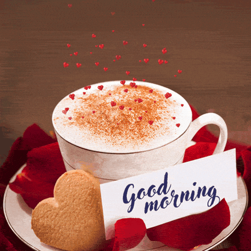 a cup of coffee with a heart shaped cookie and a card that says " good morning "