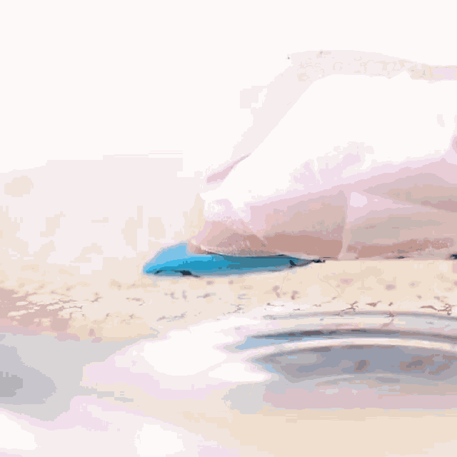 a close up of a person 's hand holding a piece of paper