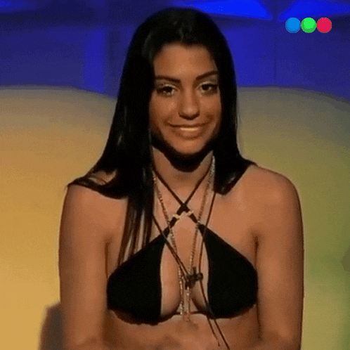 a woman in a black bikini top is smiling and looking at the camera