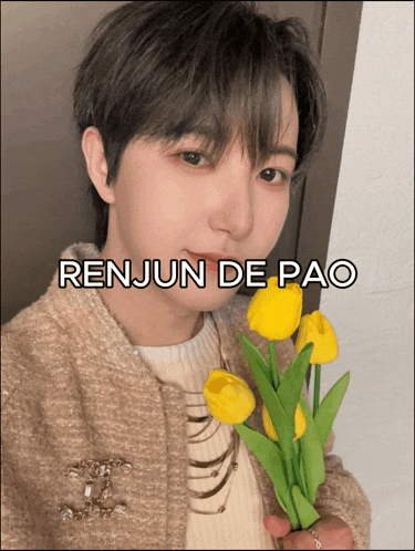 a picture of renjun de pao holding yellow flowers