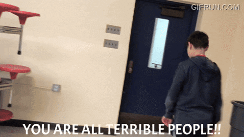 a gif from gifrun.com shows a boy standing in a hallway