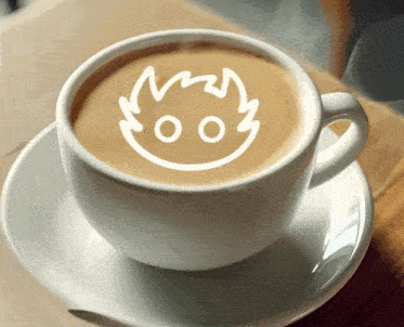 a cup of coffee on a saucer with a drawing of a face on the foam