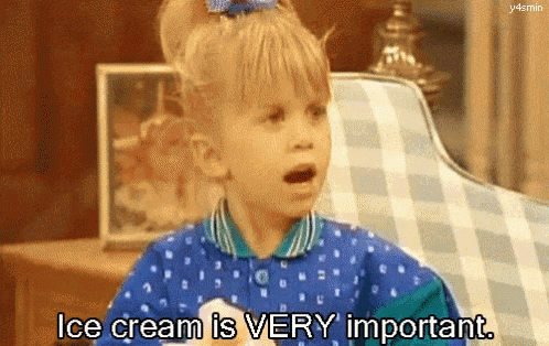 a little girl is sitting in a chair and saying ice cream is very important