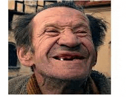 a man with a beard and a missing tooth is smiling .