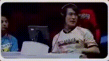 a man wearing headphones is sitting in front of a computer monitor ..