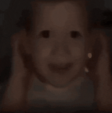 a close up of a baby 's face with a smile on it 's face .