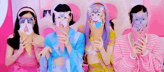 a group of girls wearing cat masks are holding ice cream cones .