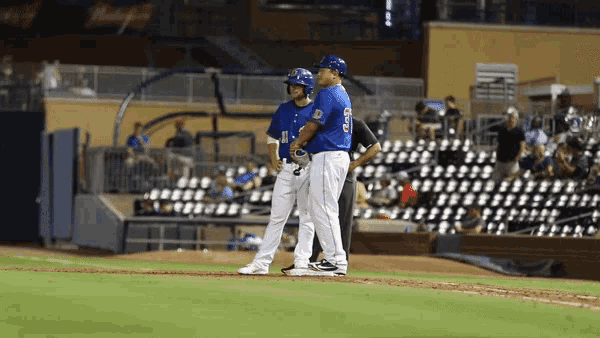 a baseball player wearing a blue jersey with the number 11 on it