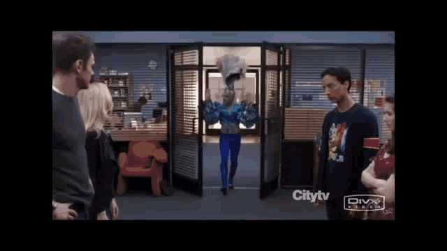 a group of people are standing in front of a door that says citytv
