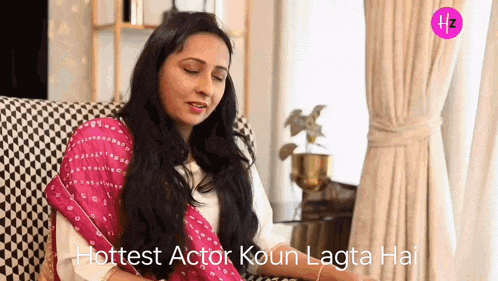 a woman is sitting on a couch with her eyes closed and the words hottest actor koun lagta hai above her .