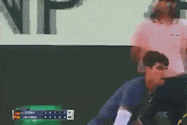 a blurred image of a tennis match between alcaraz and oveiro