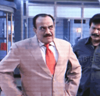 a man in a suit with a red tie is standing next to another man