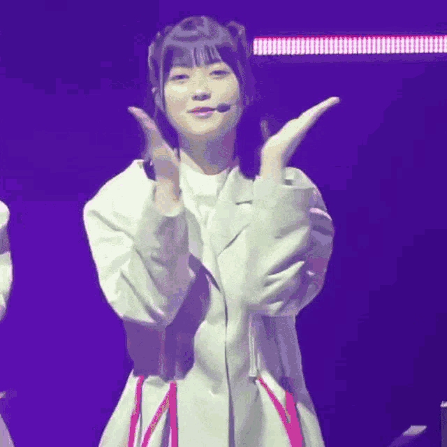 a girl in a white jacket and red skirt is dancing