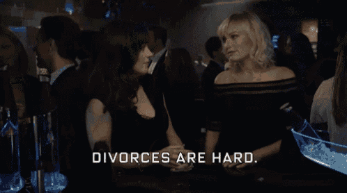 a woman is smiling while talking to another woman and the words divorces are hard are visible .