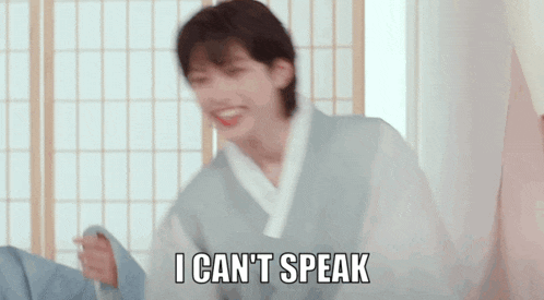 a young man in a kimono is making a funny face and says `` i can 't speak '' .