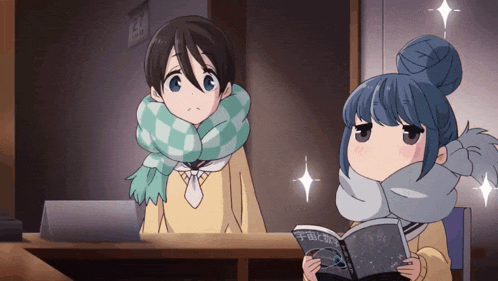 a girl is reading a book while a boy looks at a laptop
