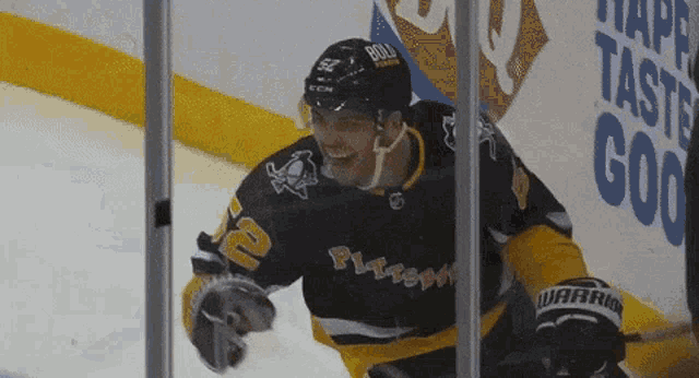 a hockey player wearing a black jersey with the number 10 on it
