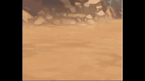 a close up of a sandy surface with a blurred background