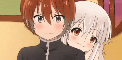 a boy and a girl are standing next to each other and the girl is making a funny face
