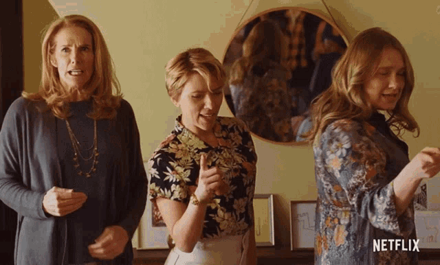three women standing next to each other with a netflix logo on the bottom right