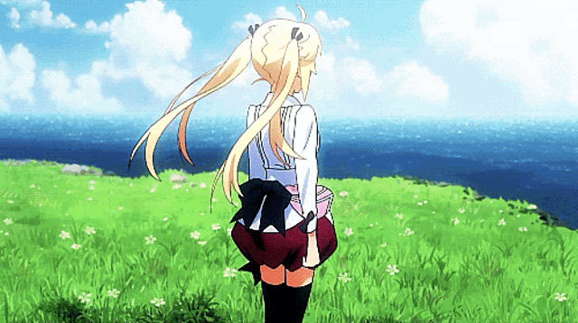 a girl with blonde hair is standing in a grassy field