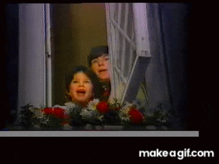 two children are looking out of a window with make a gif.com written on the bottom