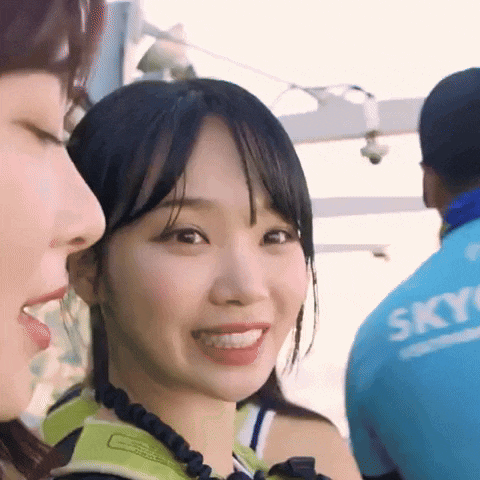 a woman wearing a blue shirt that says sky