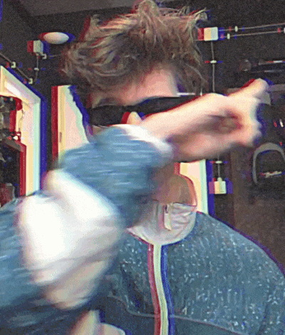 a blurry picture of a person wearing sunglasses and a blue jacket