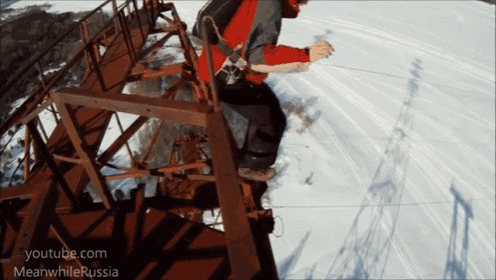 a person riding a snowboard on a staircase with youtube.com meanwhilerussia on the bottom right